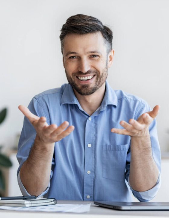 successful-handsome-businessman-sitting-at-desk-in-2022-12-16-07-48-48-utc-e1697765358247.jpg